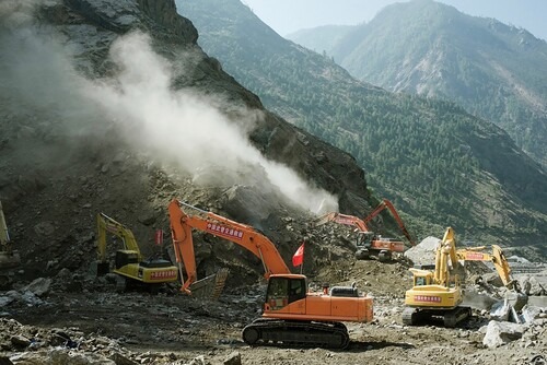 Figure 3. Chinese hydropower construction equipment clearing landslides to open borderland roads in Rasuwa district, Nepal.Source: Prasiit Sthapit, 2015.