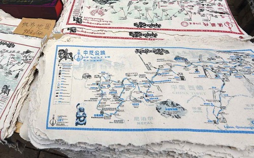 Figure 5. These maps are all printed with the following quote from the Ming Dynasty painter Qichang Dong: “Read thousands of books and walk thousands of miles” (Ch. du wan juan shu xing wan li lu), suggesting that each map purchased discloses one of innumerable routes to be experienced. Credit: designed by Scroll of Directions. Photo by author.